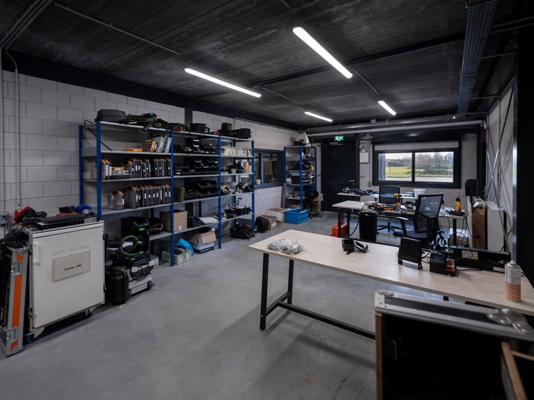 Clean organized workshop with metal shelving units and storage cabinets